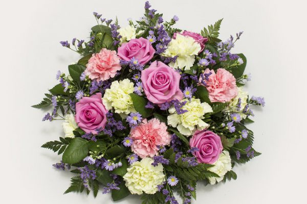 A classic posy arrangement of Carnations, Roses, September Flowers, Sea Lavender (Limonium) and greenery. From €60.