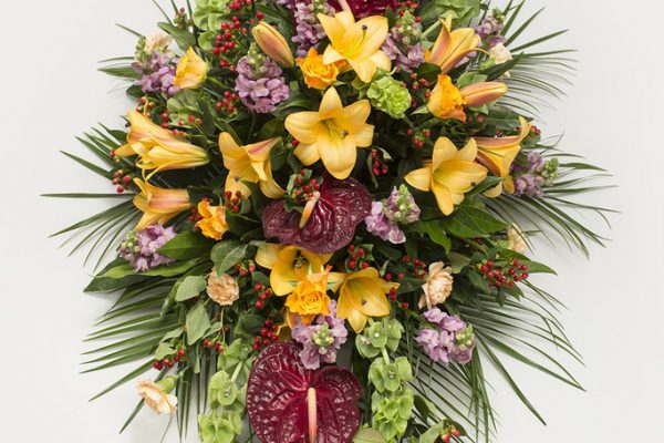 Lilies, Bells of Ireland, Roses, Carnations, Anthurium, Hypericum Berries and greenery make for a more contemporary style coffin spray. From €175.
