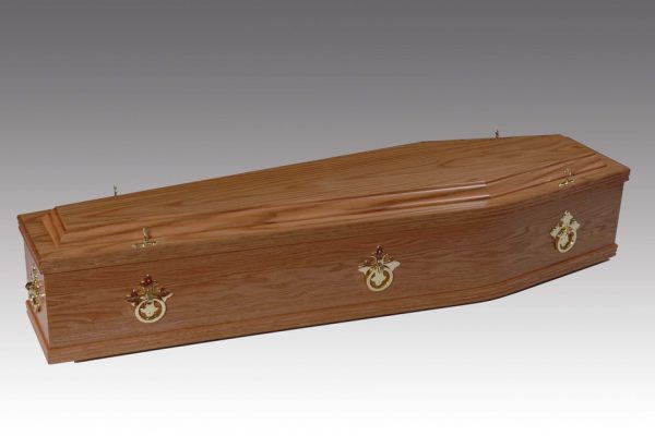 The "Chester" American Oak Coffin is fitted with brass ring mountings and a satin-lined interior.